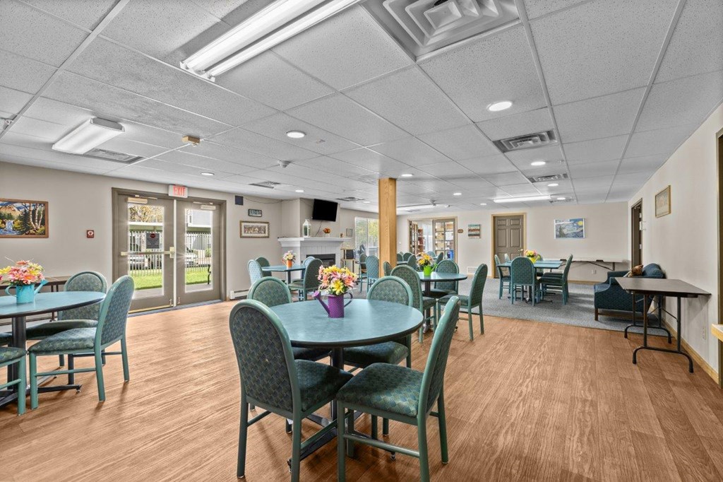 A dining room with tables and chairs.