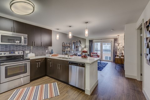 a kitchen with stainless steel appliances and a white counter top