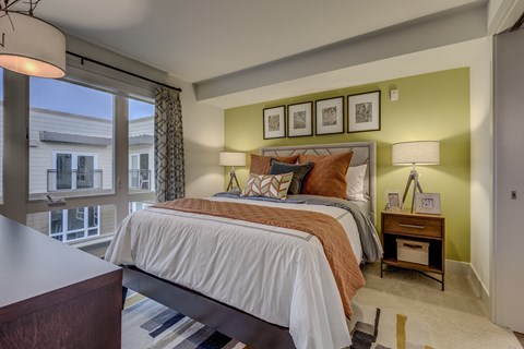 a bedroom with a large bed and a window