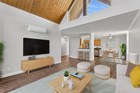 A living room with a flat screen TV mounted on the wall.
