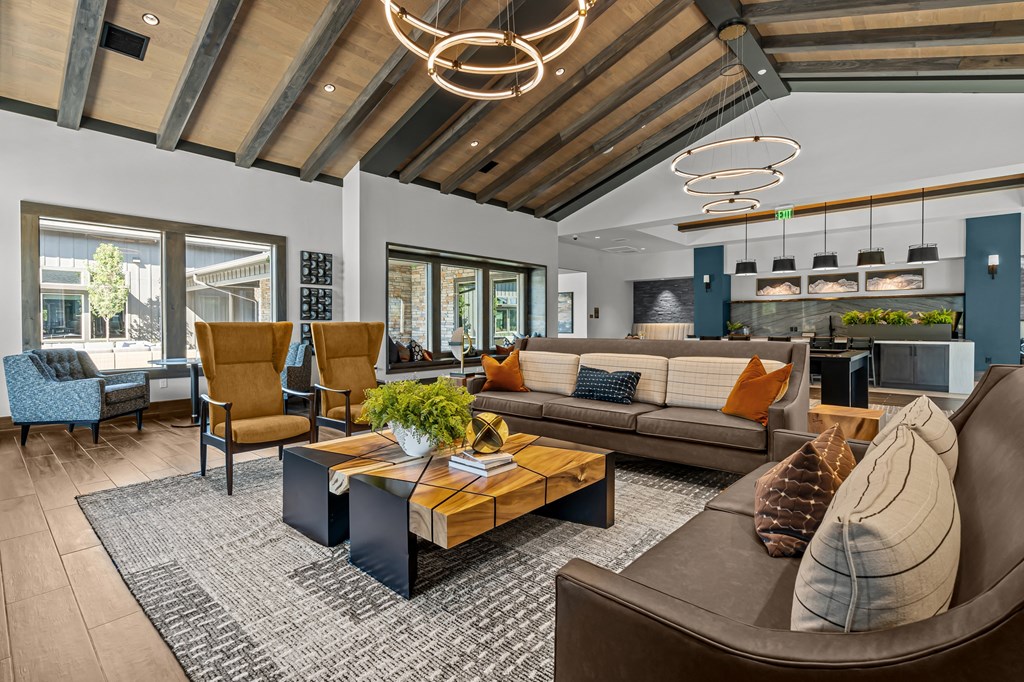 a living room with couches and chairs and a table