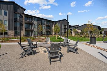 an outdoor patio with chairs and a fire pit