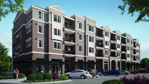 A modern apartment building with cars parked in front.