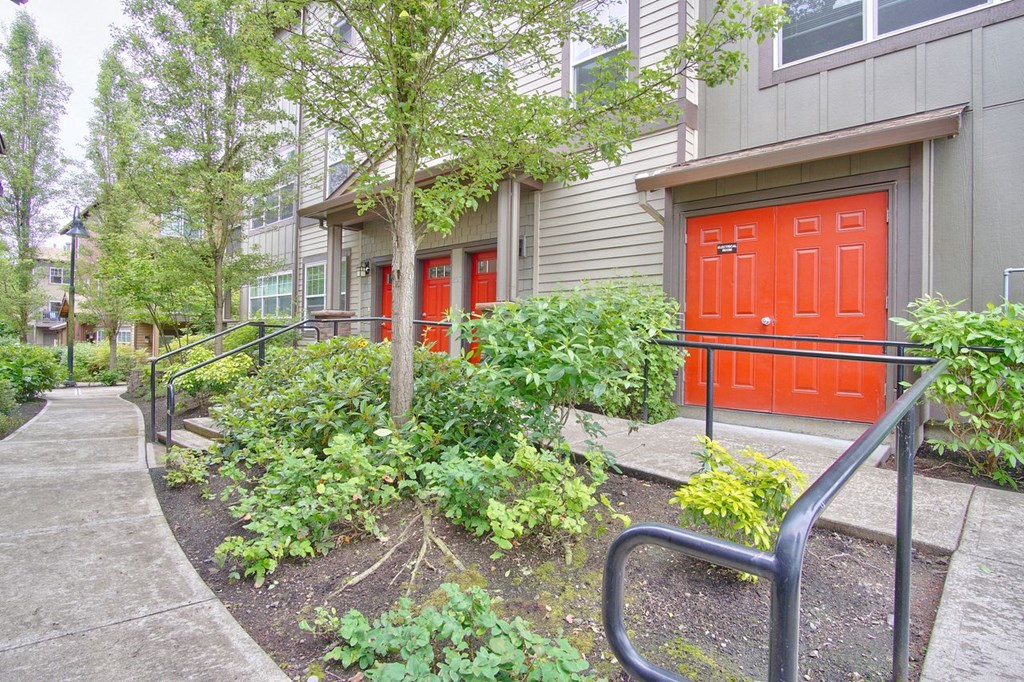 the front of a building with red doors