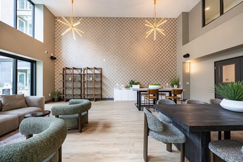 A modern living room with a dining table and chairs.