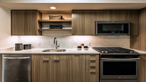 a kitchen with a stove and a sink and a microwave