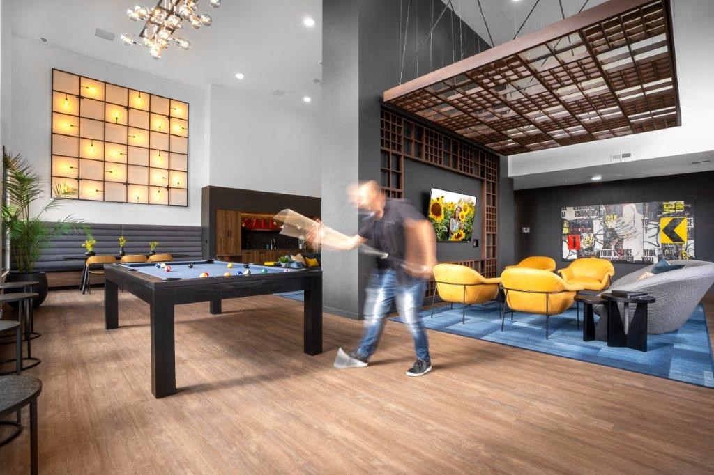 a man playing a game of pool in a living room