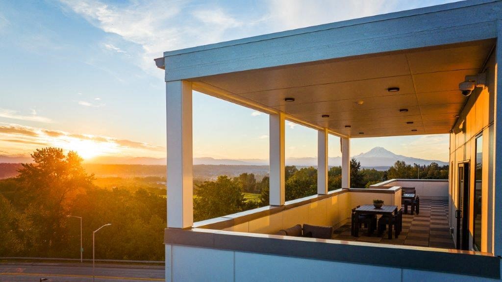 a view of the sunset from a balcony of a building