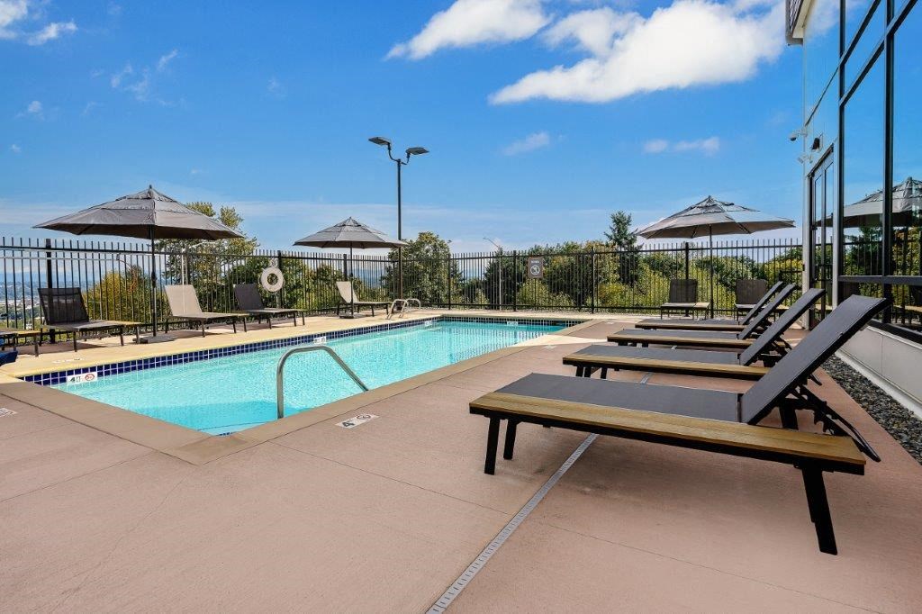 Alexan Gateway swimming pool with lounge chairs and umbrellas