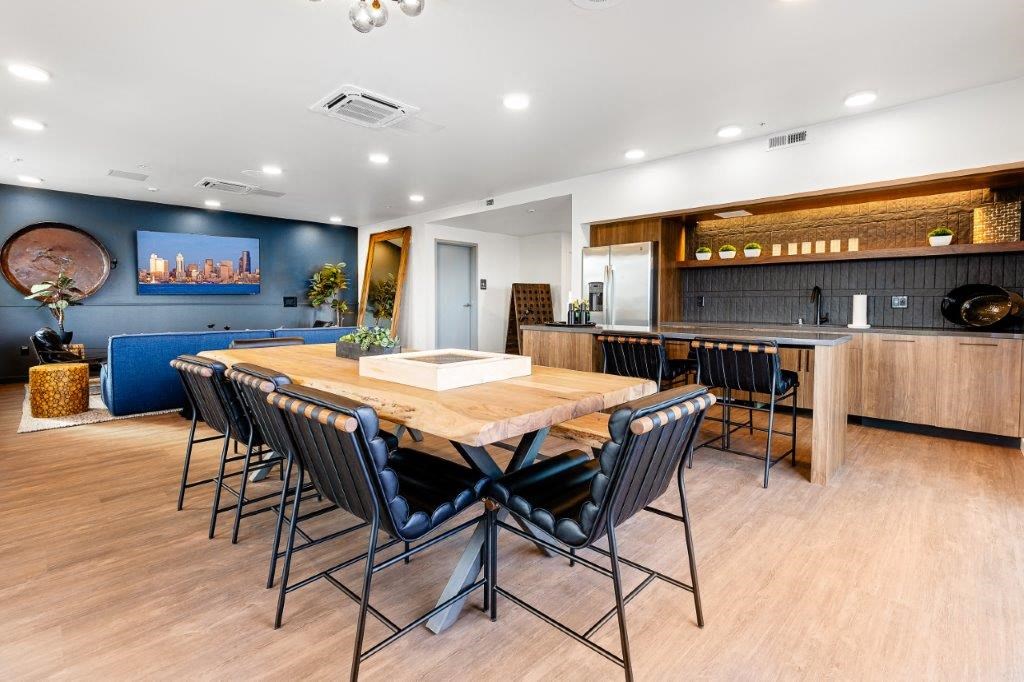 a dining room with a wooden table and chairs