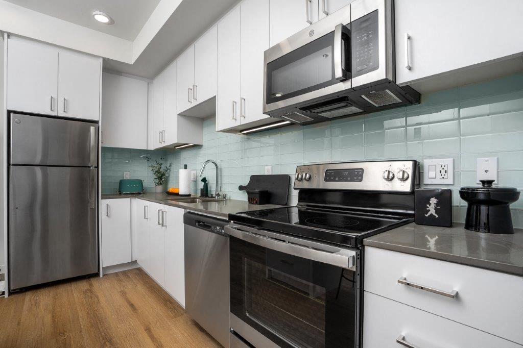 a kitchen with stainless steel appliances and a microwave