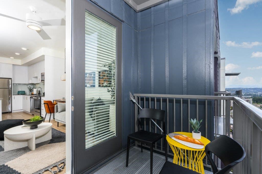 Alexan Gateway  balcony with a table and chairs