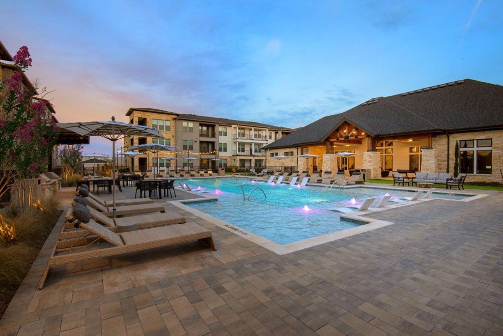 Alexan Gruene Crossing Apartments in New Braunfels, Texas Pool with Lounge Chairs