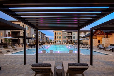 Alexan Gruene Crossing Apartments in New Braunfels, Texas Pool with Lounge Chairs