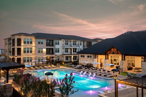 Alexan Gruene Crossing Apartments in New Braunfels, Texas Pool with Lounge Chairs