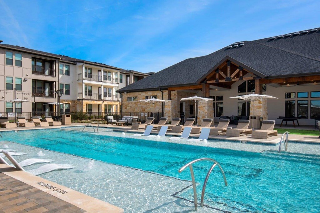 Alexan Gruene Crossing Apartments in New Braunfels, Texas Pool with Lounge Chairs
