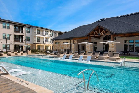 Alexan Gruene Crossing Apartments in New Braunfels, Texas Pool with Lounge Chairs