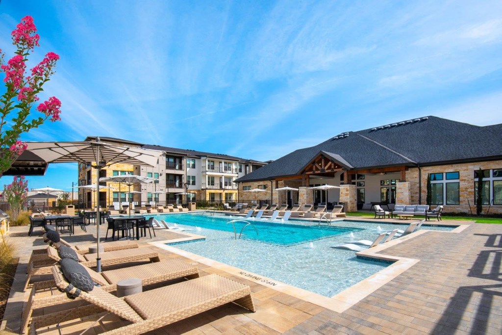 Alexan Gruene Crossing Apartments in New Braunfels, Texas Pool with Lounge Chairs