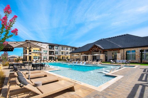 Alexan Gruene Crossing Apartments in New Braunfels, Texas Pool with Lounge Chairs