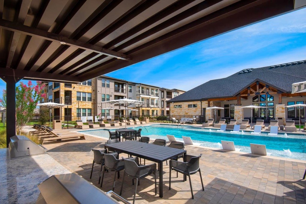 Alexan Gruene Crossing Apartments in New Braunfels, Texas Pool with Lounge Chairs
