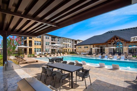 Alexan Gruene Crossing Apartments in New Braunfels, Texas Pool with Lounge Chairs