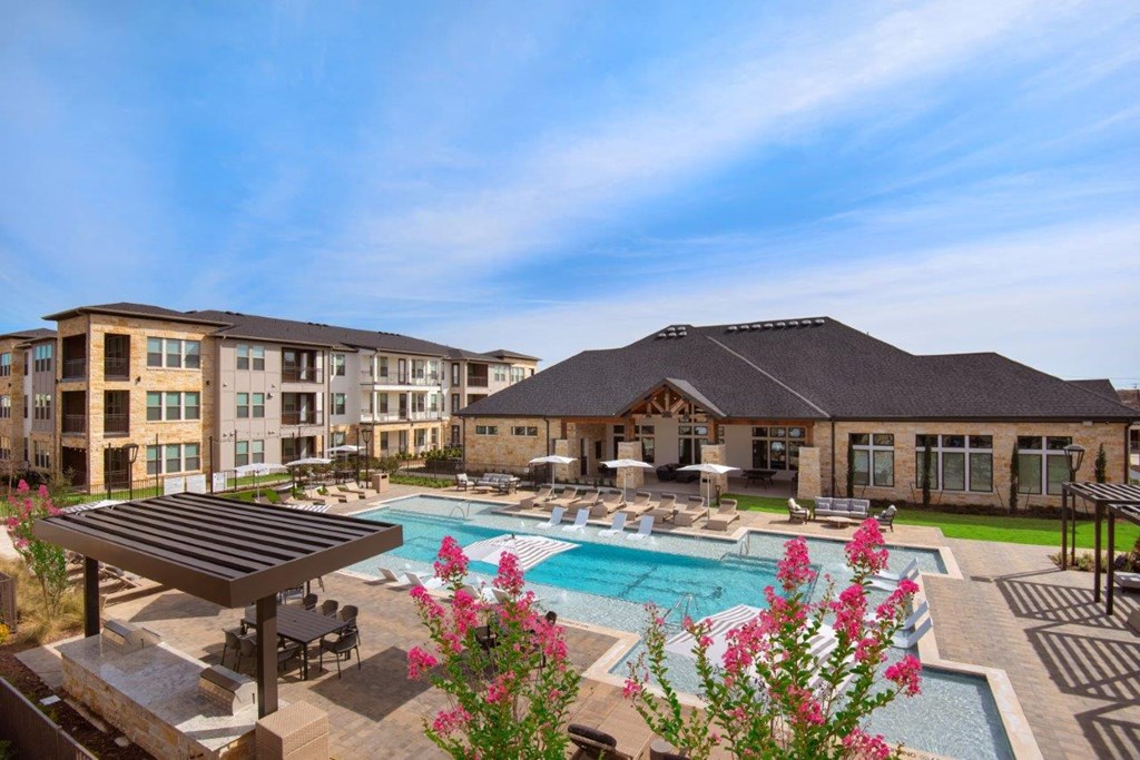 Alexan Gruene Crossing Apartments in New Braunfels, Texas Pool with Lounge Chairs