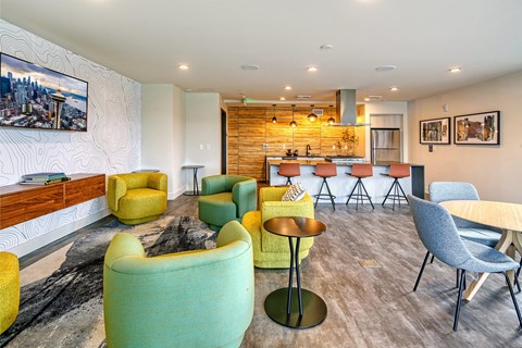 a living room with chairs and a bar and a kitchen