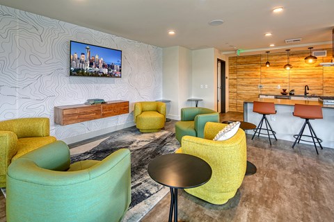 a living room with chairs and a bar and a television
