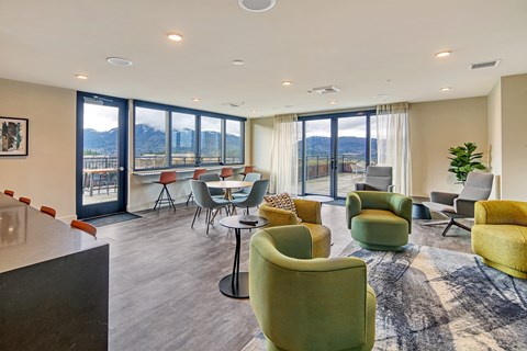 a living room with couches and chairs and a table with chairs