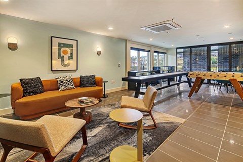 a living and dining room with a table and chairs