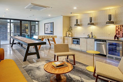 a kitchen and living room with a table and chairs