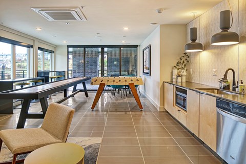 a kitchen and dining room with a table and chairs and a sink