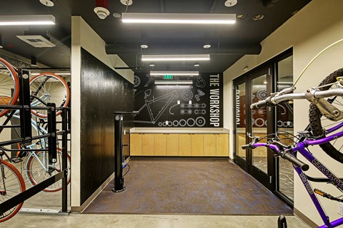 a room with bikes and a black wall with a chalkboard on it