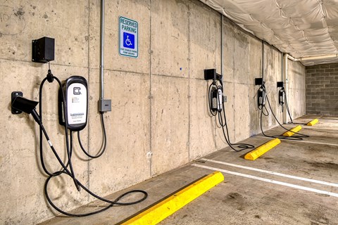 a row of charging stations on the wall of a parking garage