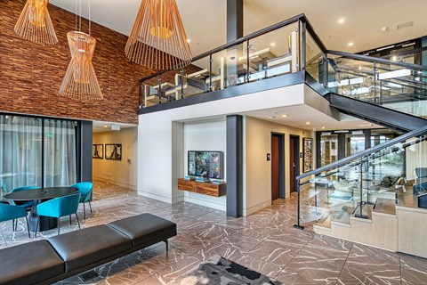 the lobby of a building with a staircase and a tv