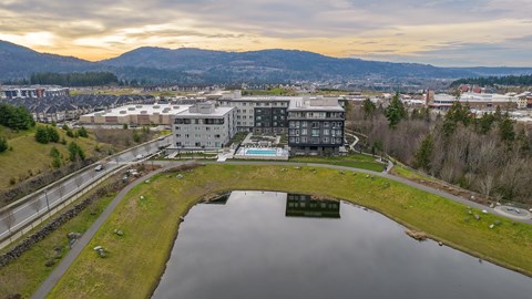 an aerial view of a city with a river and buildings