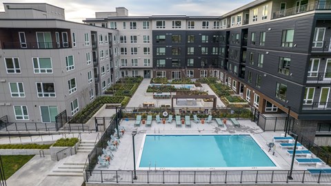 an aerial view of an apartment building with a swimming pool