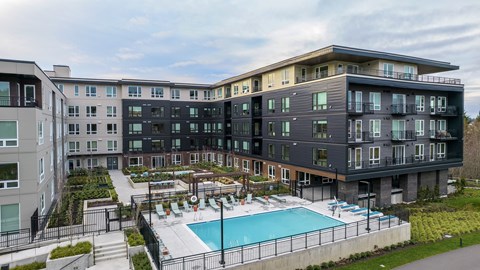 a large building with a swimming pool in front of it