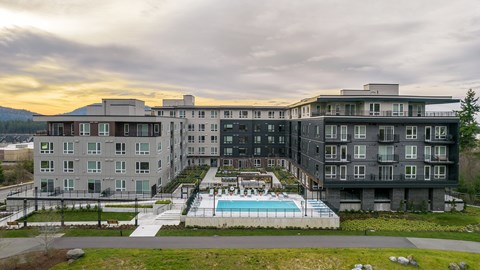 an aerial view of a building with a swimming pool