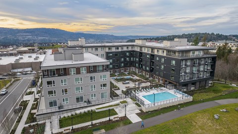 an aerial view of a large apartment building with a swimming pool