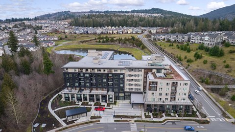 an aerial view of a building next to a road and a river
