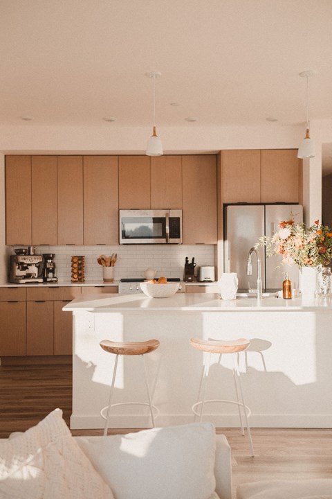 a kitchen with wooden cabinets and a white counter top
