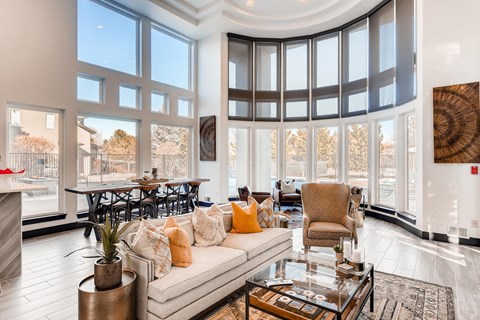 A living room with a large couch and a fireplace.