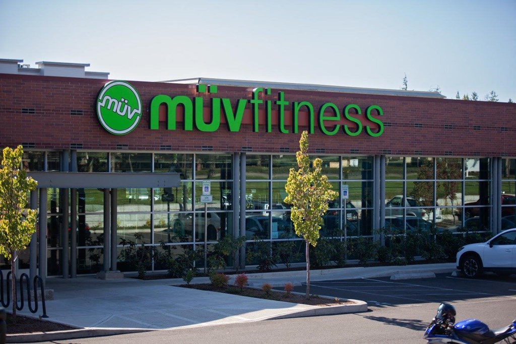 Sunset Crossing Apartments exterior street and muv fitness sign