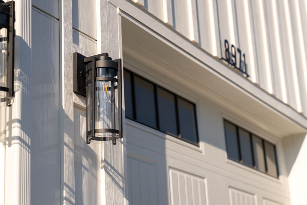 A white building with a black lantern on the side.