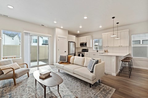 A modern living room with a white sofa and a coffee table.