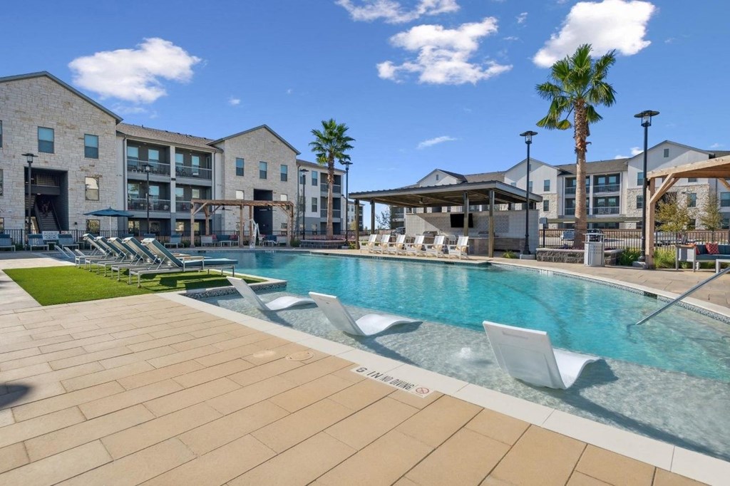 Alta Center Point Apartments in San Marcos, Texas Pool with Lounge Chairs
