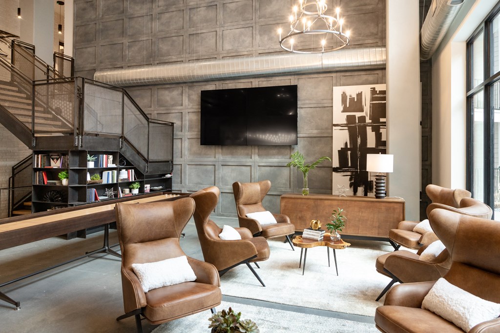 a living room filled with furniture and a flat screen tv