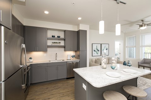 A modern kitchen with a dining table and chairs.
