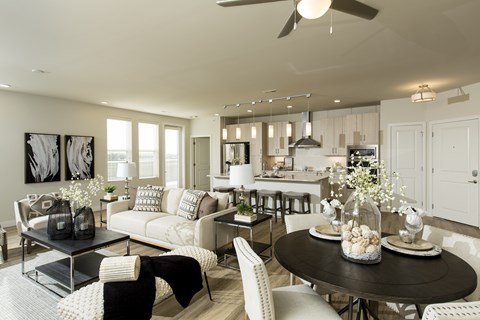 A modern living room with a black coffee table and white furniture.